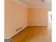 Traditional Living Room with peach walls and hardwood floors, ready for renovation at 145 Windy Ridge Ct, Fayetteville, GA 30214
