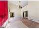 Spacious living room with tall ceilings, plywood floors and windows covered with red sheets at 145 Windy Ridge Ct, Fayetteville, GA 30214