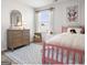 Bright bedroom featuring a wooden dresser, area rug, and a pink wooden-framed bed at 11555 Kimberly Way, Hampton, GA 30228