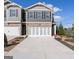 Charming two-story townhome with brick accents, white garage doors, and manicured landscaping at 11555 Kimberly Way, Hampton, GA 30228
