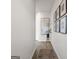 Entry hallway featuring hardwood floors and decorative artwork on white walls at 11555 Kimberly Way, Hampton, GA 30228
