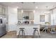 Bright, modern kitchen with stainless steel appliances, granite countertops, and breakfast bar at 11555 Kimberly Way, Hampton, GA 30228