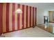 Dining room with a striped accent wall, wood floors, fireplace and ample natural light at 4014 Oak Stone Dr, Douglasville, GA 30135