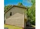 Side view of house and the lush greenery surrounding it showcases its serene location at 4014 Oak Stone Dr, Douglasville, GA 30135