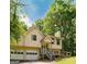 Exterior of home featuring a front entrance with a porch, two-car garage and mature trees surrounding the property at 4014 Oak Stone Dr, Douglasville, GA 30135
