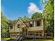 Charming two-story home with a front porch, two-car garage and mature trees surrounding the property at 4014 Oak Stone Dr, Douglasville, GA 30135