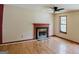 Inviting living room featuring wood floors, a fireplace and natural light from the window at 4014 Oak Stone Dr, Douglasville, GA 30135