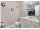 Modern bathroom with white cabinets, marbled floors, and decorative mirrors at 1848 Eastmore Ave, Conyers, GA 30094