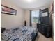 Cozy bedroom with a blue patterned bedspread and dark wood furniture at 1848 Eastmore Ave, Conyers, GA 30094
