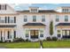 Charming townhome with white siding, black roof, and a well-manicured lawn and landscaped garden at 1848 Eastmore Ave, Conyers, GA 30094