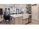 Open-concept kitchen with a large island and modern stainless steel appliances and adjacent living room at 1848 Eastmore Ave, Conyers, GA 30094