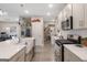 This open kitchen features quartz countertops, an island, and sleek stainless steel appliances at 1848 Eastmore Ave, Conyers, GA 30094