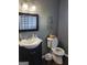 Neat bathroom with classic vanity, framed mirror, and toilet with faith-inspired wall decor at 45 Surrey Chase Dr, Social Circle, GA 30025