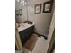 Cozy bathroom featuring a modern sink, tiled floors, and a well-lit vanity mirror at 45 Surrey Chase Dr, Social Circle, GA 30025