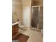 Neutral bathroom featuring a white toilet, wooden vanity, tile flooring, and glass shower door at 45 Surrey Chase Dr, Social Circle, GA 30025
