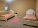 Comfortable bedroom with two twin beds, carpeted floors, and a cozy, inviting atmosphere at 45 Surrey Chase Dr, Social Circle, GA 30025