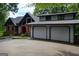 Charming two-story home featuring a two-car garage, brick accents and mature trees at 45 Surrey Chase Dr, Social Circle, GA 30025