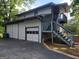 Spacious garage with a convenient drive way and adjacent stairs to an upper level deck at 45 Surrey Chase Dr, Social Circle, GA 30025
