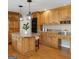 Well-equipped kitchen with a central island, granite countertops, and sleek, modern lighting at 45 Surrey Chase Dr, Social Circle, GA 30025