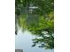 Scenic view of a peaceful lake with a gazebo and surrounding trees at 45 Surrey Chase Dr, Social Circle, GA 30025