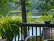 Scenic lake view with gazebo framed by foliage on a sunlit day at 45 Surrey Chase Dr, Social Circle, GA 30025