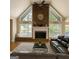 Spacious living room with cathedral ceiling, large brick fireplace, and lots of windows at 45 Surrey Chase Dr, Social Circle, GA 30025