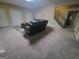 Spacious basement living area with a large sectional sofa, plush carpet, staircase, and neutral wall color at 45 Surrey Chase Dr, Social Circle, GA 30025