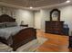 Spacious main bedroom offering dark wood furnishings and a plush carpet at 45 Surrey Chase Dr, Social Circle, GA 30025