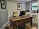Classic office space featuring an antique desk with a computer setup and comfortable executive chair at 45 Surrey Chase Dr, Social Circle, GA 30025