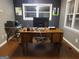 Home office with wooden desk, natural light, and neutral wall colors, perfect for productivity at 45 Surrey Chase Dr, Social Circle, GA 30025