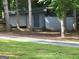 View of the outbuilding surrounded by trees, with driveway access and ample storage space for outdoor equipment at 45 Surrey Chase Dr, Social Circle, GA 30025