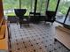 Bright sunroom featuring patterned tile flooring, modern chairs, and scenic lake views at 45 Surrey Chase Dr, Social Circle, GA 30025