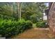 The backyard with mature trees surrounding the patio of the home at 1517 Indian Forest Trl, Stone Mountain, GA 30083