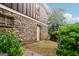 A brick home and patio surrounded by lush greenery in the backyard at 1517 Indian Forest Trl, Stone Mountain, GA 30083