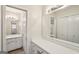 Bathroom features dual sinks with white cabinets and large mirrors at 1517 Indian Forest Trl, Stone Mountain, GA 30083