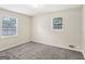 Bedroom featuring two windows and neutral carpeting at 1517 Indian Forest Trl, Stone Mountain, GA 30083