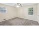 Bright bedroom featuring a ceiling fan and two windows at 1517 Indian Forest Trl, Stone Mountain, GA 30083