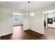 Bright dining room showcasing hardwood floors and open access to other rooms at 1517 Indian Forest Trl, Stone Mountain, GA 30083