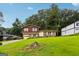 Charming split-level home with brown wood and brick exterior, attached garage, and grassy front yard at 1517 Indian Forest Trl, Stone Mountain, GA 30083