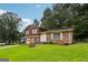 Split-level home featuring a brick and wood facade, attached garage, and well-manicured lawn at 1517 Indian Forest Trl, Stone Mountain, GA 30083
