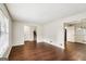 Open-concept living area with wood floors and access to stairs and dining room at 1517 Indian Forest Trl, Stone Mountain, GA 30083
