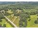 Aerial view of the house surrounded by lush forest, green lawn, and a private driveway at 949 Amelia Rd, Locust Grove, GA 30248