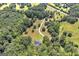 Picturesque aerial shot showcasing a home nestled among mature trees, offering privacy and tranquility at 949 Amelia Rd, Locust Grove, GA 30248