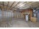 Unfinished basement with exposed ceiling, framing, and concrete flooring offers many possibilities at 949 Amelia Rd, Locust Grove, GA 30248