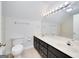 Bathroom featuring a double sink vanity, a toilet, and a tiled shower and tub combination at 949 Amelia Rd, Locust Grove, GA 30248