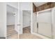 This bathroom has tiled floors, a glass enclosed shower, and entryways to an adjacent bedroom and closet at 949 Amelia Rd, Locust Grove, GA 30248