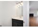 Powder room with a dark vanity, countertop and plumbing fixtures at 949 Amelia Rd, Locust Grove, GA 30248