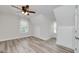 Cozy bedroom with vaulted ceilings, ceiling fan, wood-look flooring, and natural light from multiple windows at 949 Amelia Rd, Locust Grove, GA 30248