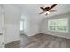 Upstairs bedroom with wood-look flooring, natural light, and multiple storage closets at 949 Amelia Rd, Locust Grove, GA 30248
