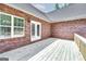 View of the spacious wooden deck with access to the interior of the brick home at 949 Amelia Rd, Locust Grove, GA 30248